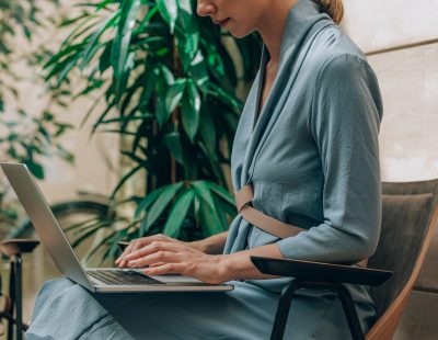 Hands of unrecognisable businesswoman typing on her laptop.